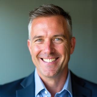 Professional headshot of Mark Thompson